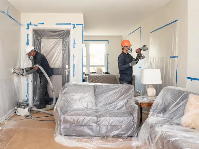 Renovation crew preparing dust controlled sanding